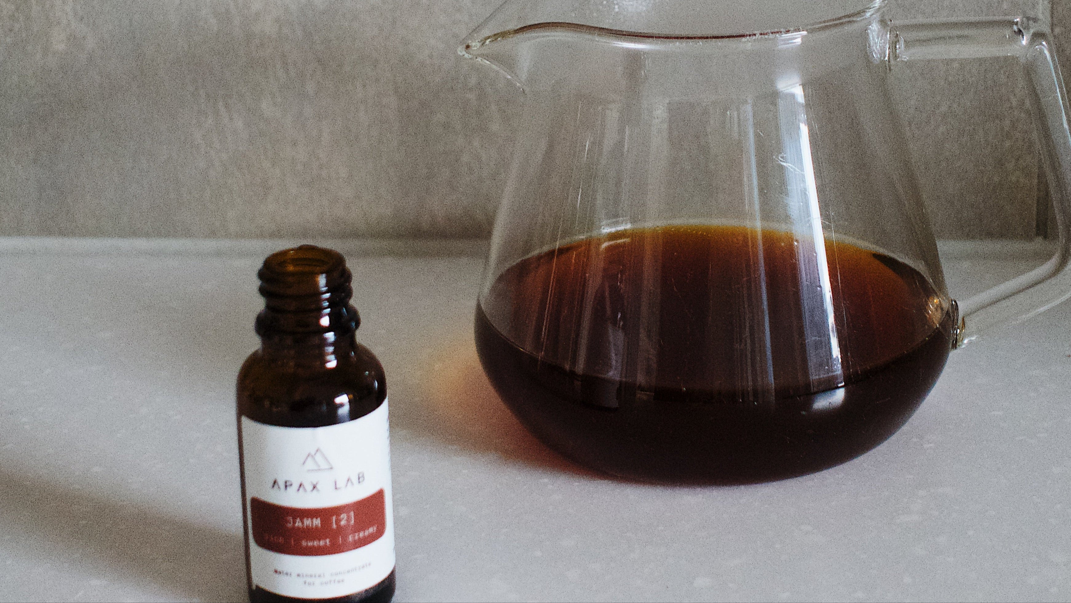 Adding Apax Lab mineral drops directly into a brewed cup of coffee for post-brew flavour adjustment

