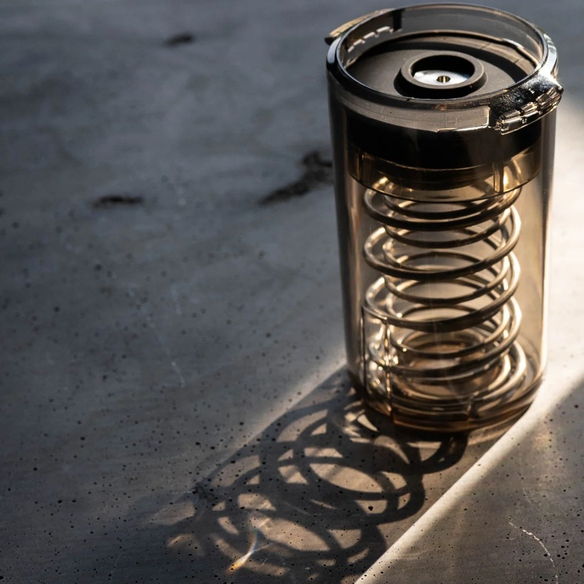 Spring Clean Weber Workshops Espresso Cleaner featuring a transparent container with a spiral design.