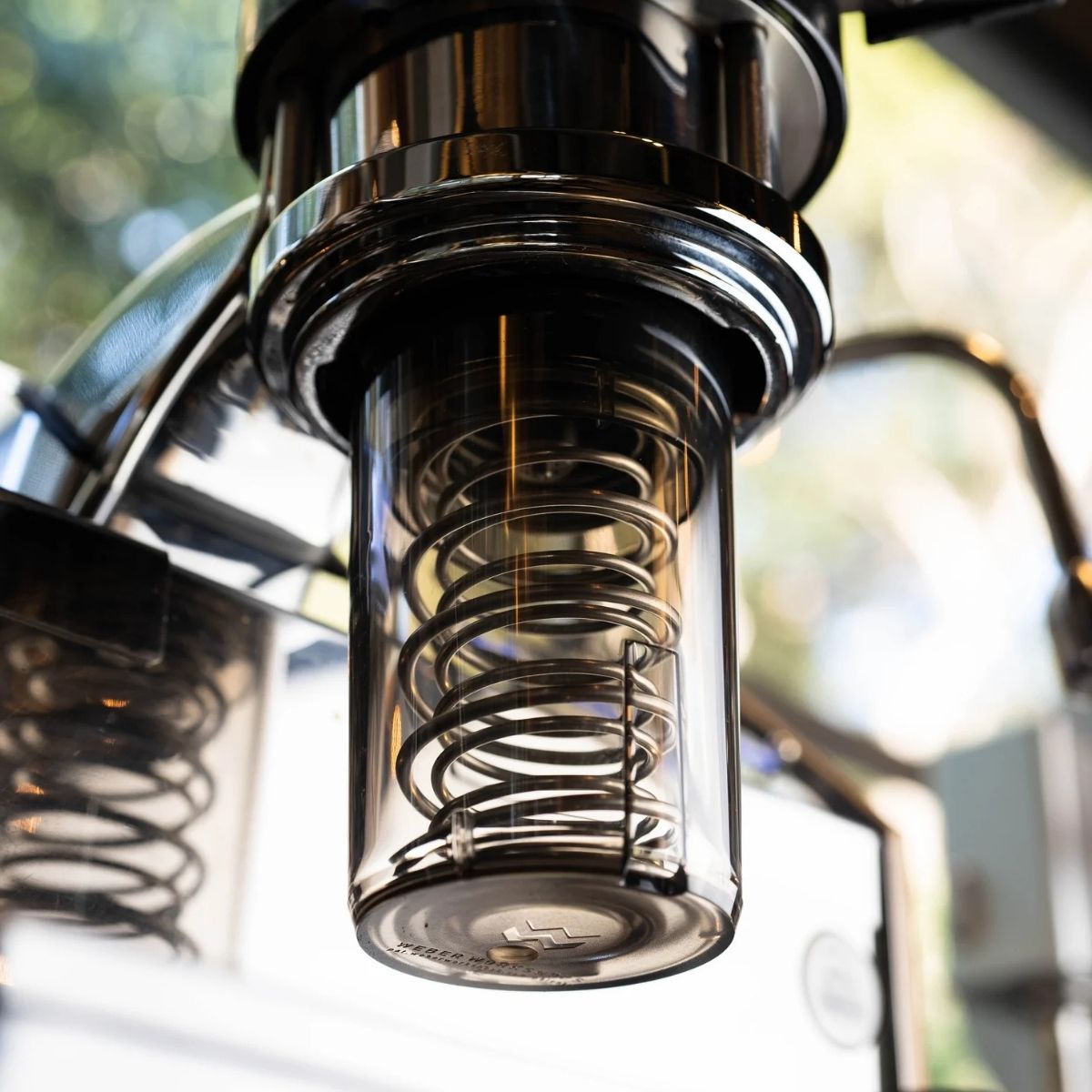 Spring Clean Weber Workshops Espresso Cleaner in close-up, showcasing the inner components of an espresso machine with a clear coil design.
